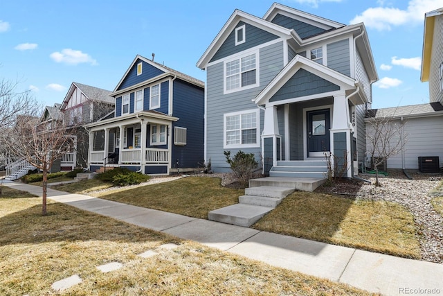 view of front of house featuring a porch, central AC, and a front yard