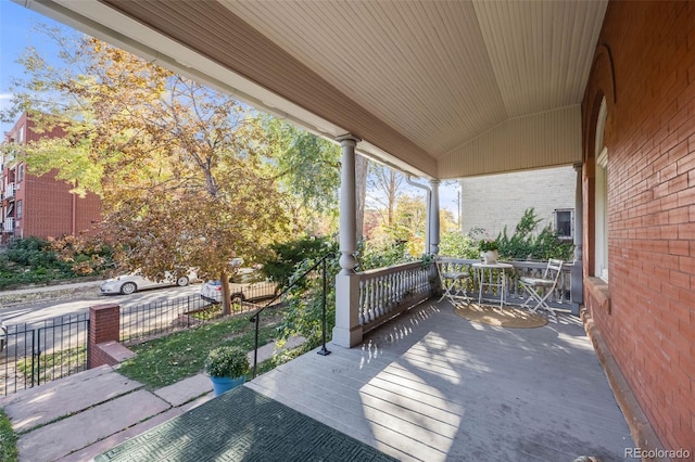 view of patio with covered porch and fence