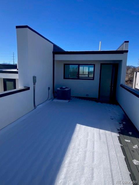 rear view of house with stucco siding