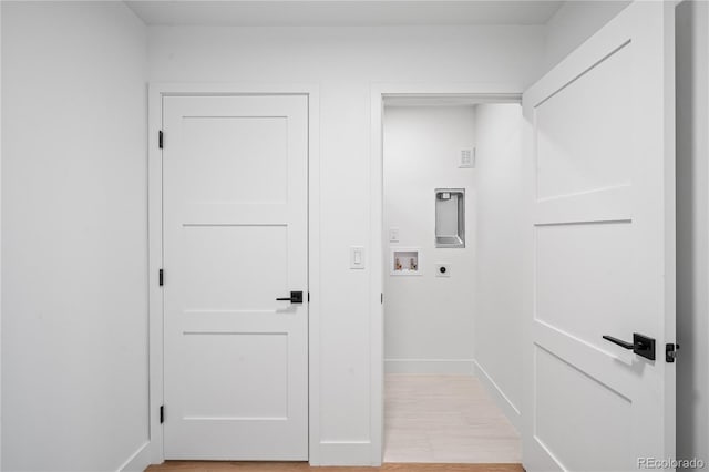 washroom featuring hookup for an electric dryer, laundry area, washer hookup, baseboards, and light wood finished floors