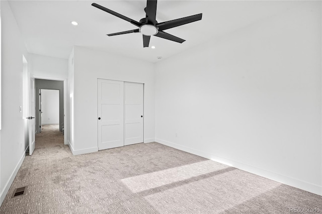 unfurnished bedroom featuring light carpet, visible vents, baseboards, a closet, and recessed lighting