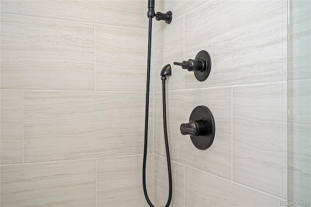 interior details featuring a tile shower