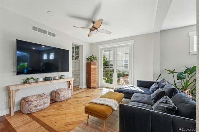 8256 E 28th Dr, Denver, CO 80238 - living area with wood finished floors, ceiling fan, healthy amount of natural light, and baseboards