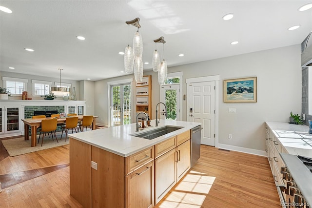 8256 E 28th Dr, Denver, CO 80238 - kitchen featuring a sink, dishwasher, baseboards, light wood-style floors, and recessed lighting