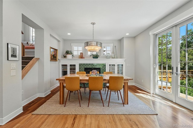 8256 E 28th Dr, Denver, CO 80238 - dining area featuring wood finished floors, baseboards, recessed lighting, french doors, and a chandelier