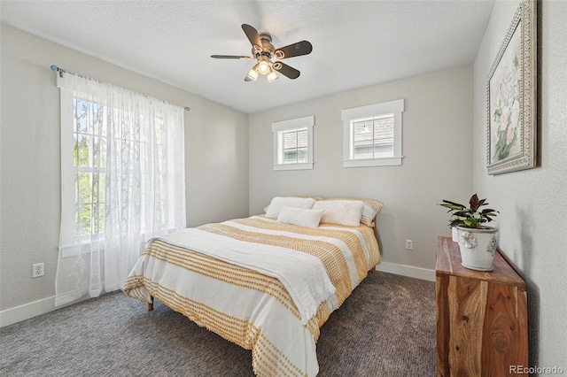 8256 E 28th Dr, Denver, CO 80238 - carpeted bedroom featuring baseboards and a ceiling fan