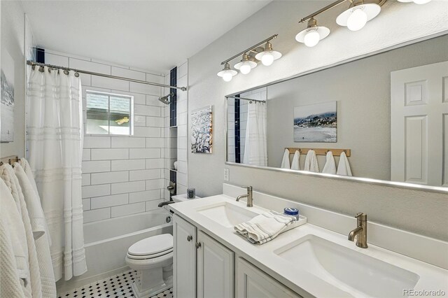 8256 E 28th Dr, Denver, CO 80238 - full bath with double vanity, toilet, shower / bath combination with curtain, and tile patterned floors