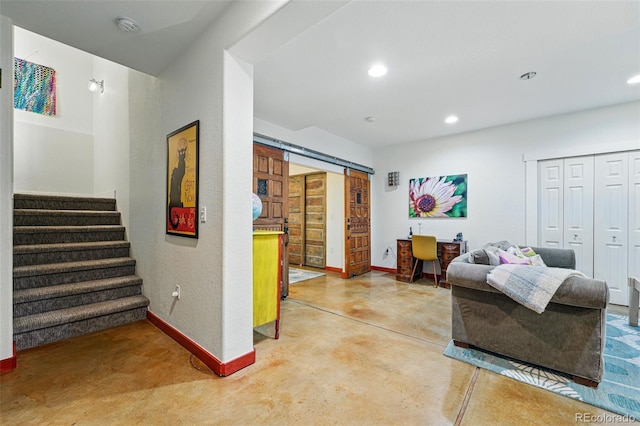 8256 E 28th Dr, Denver, CO 80238 - living room featuring concrete floors, a barn door, baseboards, stairway, and recessed lighting