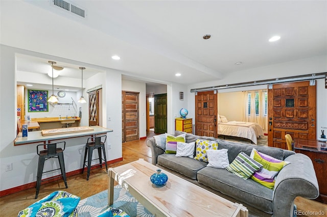8256 E 28th Dr, Denver, CO 80238 - living area featuring a barn door, recessed lighting, and baseboards