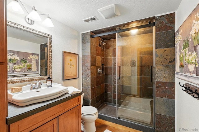 8256 E 28th Dr, Denver, CO 80238 - full bath featuring a stall shower, toilet, a textured ceiling, and vanity
