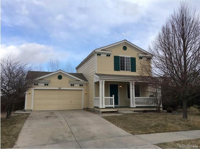 traditional-style home with covered porch, an attached garage, and concrete driveway