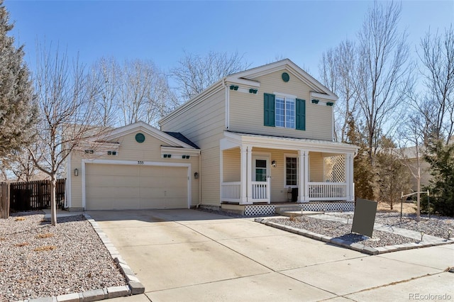 traditional-style house with a garage, driveway, a porch, and fence