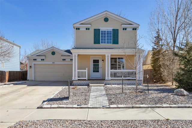 traditional-style house featuring a porch, concrete driveway, fence, and a garage