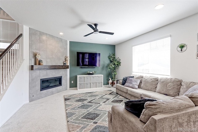 9835 Uravan St, Commerce City, CO 80022 - living area with ceiling fan, a tile fireplace, carpet floors, stairs, and recessed lighting