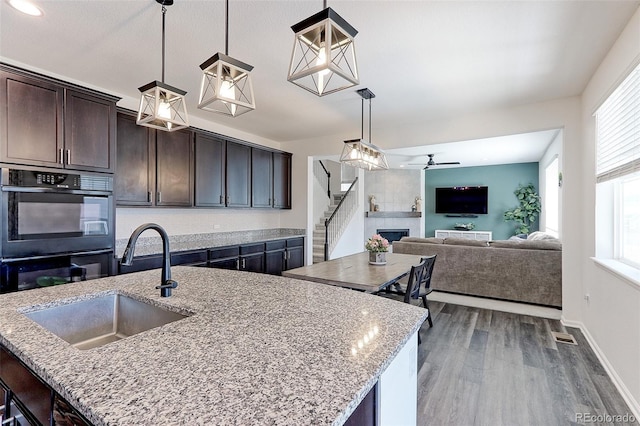 9835 Uravan St, Commerce City, CO 80022 - kitchen with a sink, a ceiling fan, dark brown cabinetry, and plenty of natural light