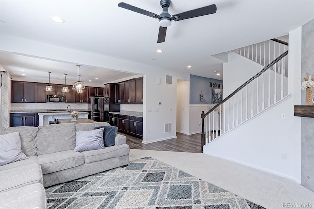9835 Uravan St, Commerce City, CO 80022 - living area with a ceiling fan, stairs, recessed lighting, baseboards, and carpet