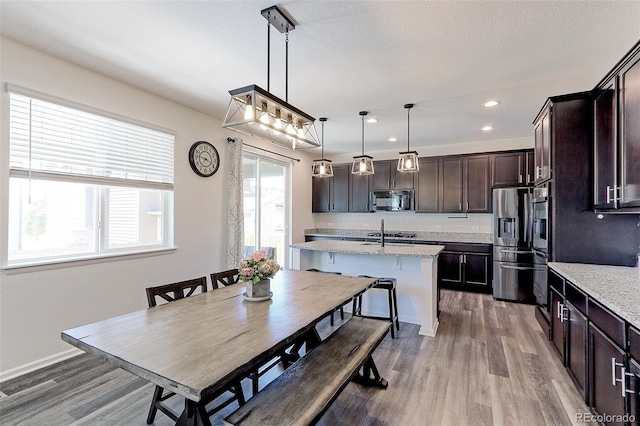 9835 Uravan St, Commerce City, CO 80022 - dining room featuring light wood finished floors, recessed lighting, and baseboards