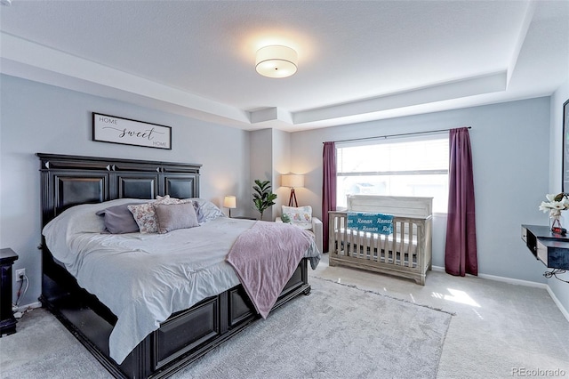9835 Uravan St, Commerce City, CO 80022 - bedroom featuring a tray ceiling, carpet flooring, and baseboards