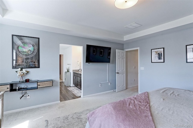 9835 Uravan St, Commerce City, CO 80022 - bedroom featuring light colored carpet, baseboards, and ensuite bath