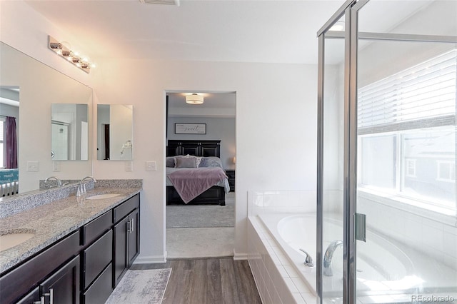 9835 Uravan St, Commerce City, CO 80022 - full bath with ensuite bathroom, wood finished floors, a garden tub, double vanity, and a shower stall