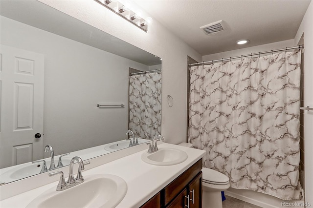 9835 Uravan St, Commerce City, CO 80022 - full bath with double vanity, toilet, and tile patterned flooring