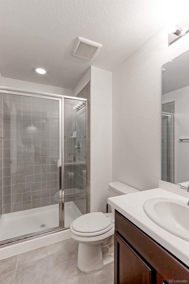 9835 Uravan St, Commerce City, CO 80022 - full bathroom with a stall shower, a textured ceiling, tile patterned floors, vanity, and recessed lighting