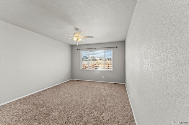 unfurnished room with ceiling fan, a textured ceiling, and carpet