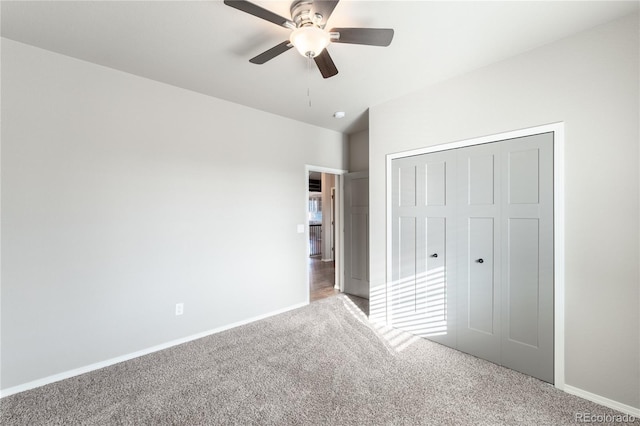 unfurnished bedroom featuring ceiling fan, a closet, and carpet