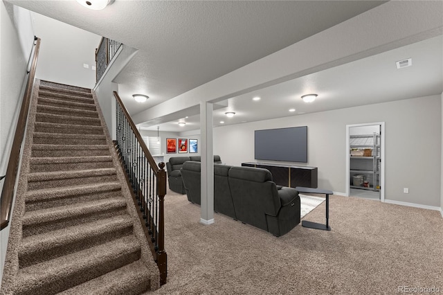 living room with carpet flooring and a textured ceiling