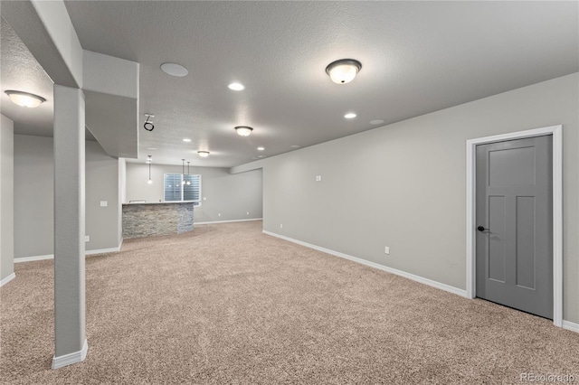 basement featuring carpet and a textured ceiling