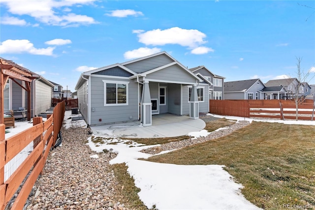 view of front of property featuring a front lawn and a patio