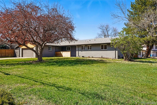 12345 W 32nd Ave, Wheat Ridge, CO 80033 - ranch-style house featuring fence, a front lawn, brick siding, an attached garage, and concrete driveway