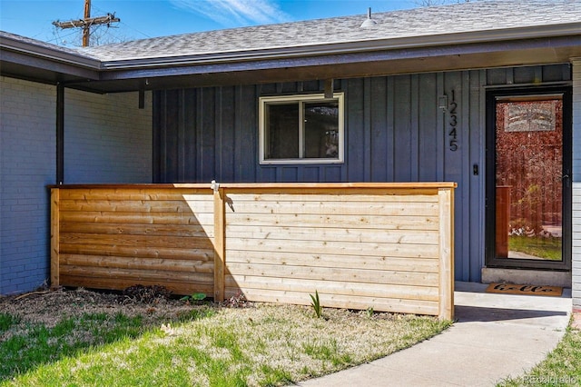 12345 W 32nd Ave, Wheat Ridge, CO 80033 - property entrance featuring board and batten siding, a shingled roof, and brick siding