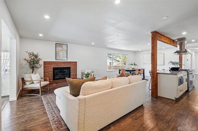 12345 W 32nd Ave, Wheat Ridge, CO 80033 - living room featuring a fireplace, recessed lighting, dark wood-style floors, and baseboards