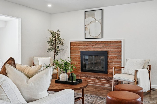 12345 W 32nd Ave, Wheat Ridge, CO 80033 - living room with recessed lighting, a brick fireplace, visible vents, and wood finished floors