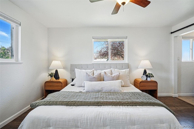 12345 W 32nd Ave, Wheat Ridge, CO 80033 - bedroom featuring baseboards, a ceiling fan, a barn door, and wood finished floors