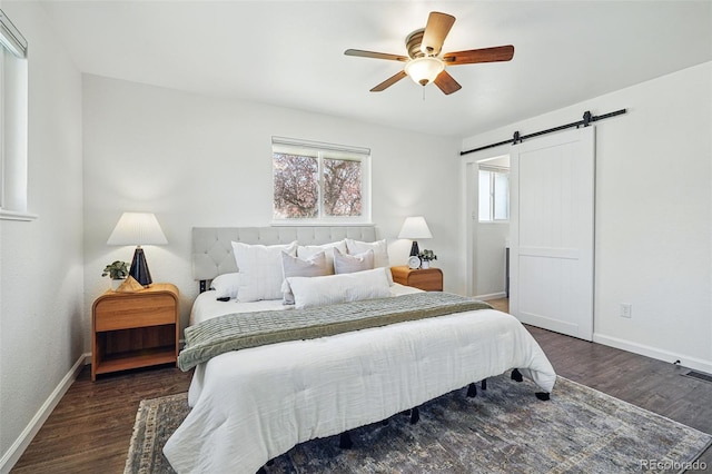 12345 W 32nd Ave, Wheat Ridge, CO 80033 - bedroom with wood finished floors, baseboards, a ceiling fan, and a barn door