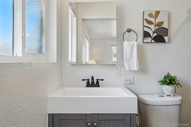 12345 W 32nd Ave, Wheat Ridge, CO 80033 - bathroom with toilet, a textured wall, and vanity