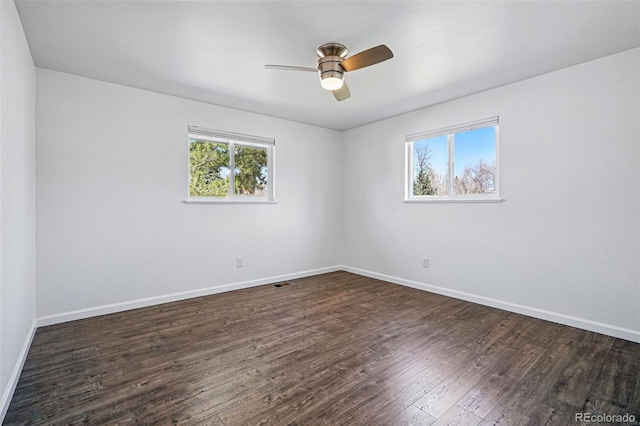 12345 W 32nd Ave, Wheat Ridge, CO 80033 - unfurnished room featuring visible vents, baseboards, a ceiling fan, and dark wood finished floors