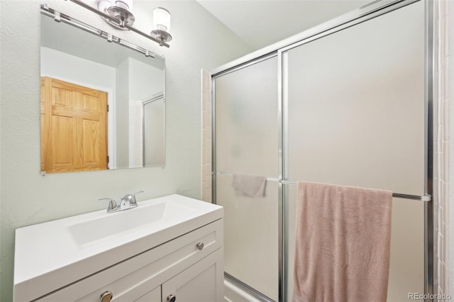 full bath featuring vanity and a shower stall