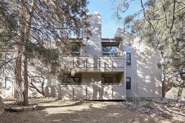 back of property with a balcony