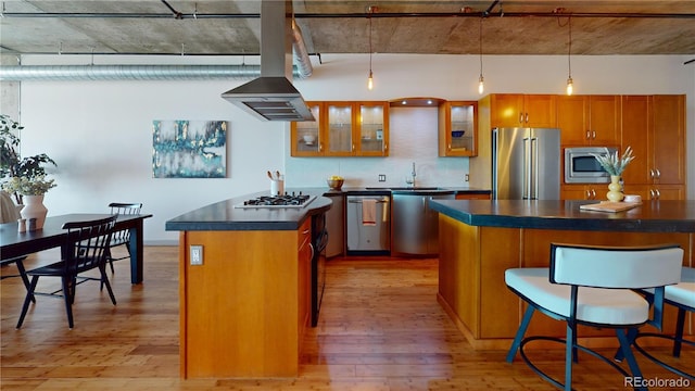 1401 Wewatta St Unit 808, Denver, CO 80202 - kitchen with glass insert cabinets, brown cabinets, dark countertops, stainless steel appliances, and light wood-type flooring