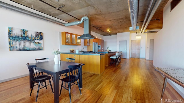 1401 Wewatta St Unit 808, Denver, CO 80202 - dining space with visible vents, light wood-style flooring, and baseboards
