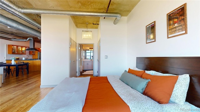 1401 Wewatta St Unit 808, Denver, CO 80202 - bedroom with wood finished floors and a towering ceiling