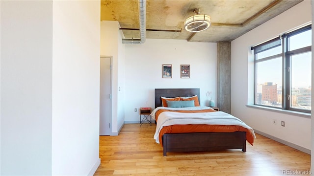 1401 Wewatta St Unit 808, Denver, CO 80202 - bedroom featuring light wood-type flooring, baseboards, and ceiling fan