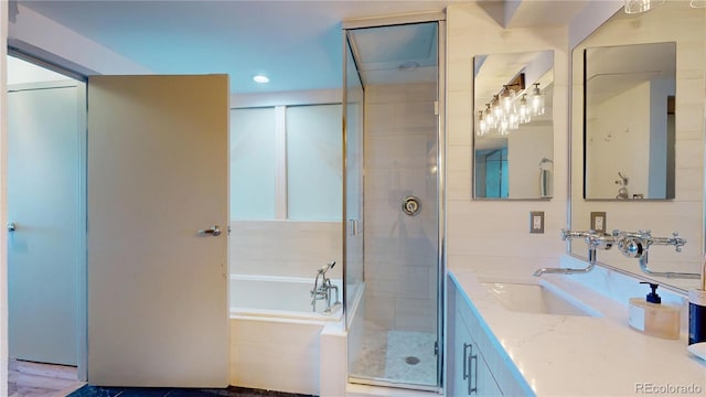 1401 Wewatta St Unit 808, Denver, CO 80202 - full bath featuring a stall shower, a bath, vanity, and recessed lighting