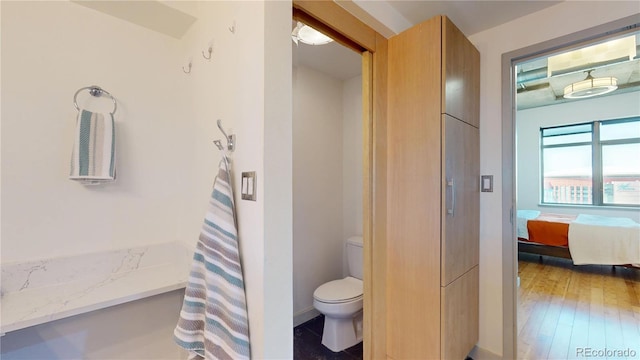 1401 Wewatta St Unit 808, Denver, CO 80202 - full bath with toilet, connected bathroom, and wood finished floors