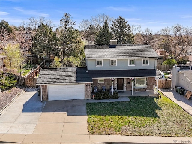 traditional-style home with driveway, brick siding, a front lawn, and fence