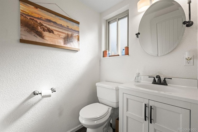 half bathroom featuring vanity and toilet