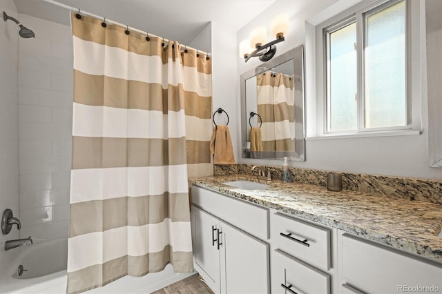 bathroom featuring vanity, wood finished floors, and shower / bathtub combination with curtain